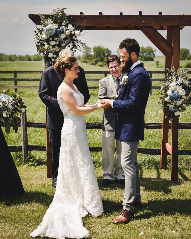 A couple has their wedding in a field at The Vermont Wedding Barn at Champlain Valley Alpacas