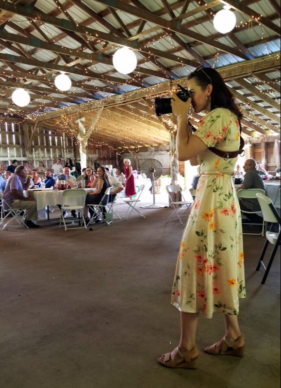 Vermont Wedding Photographer takes pictures inside of a barn venue.